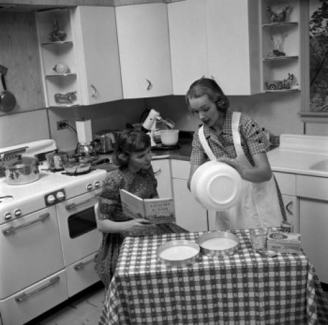 Two young women cooking Canvas Art - (18 x 24)
