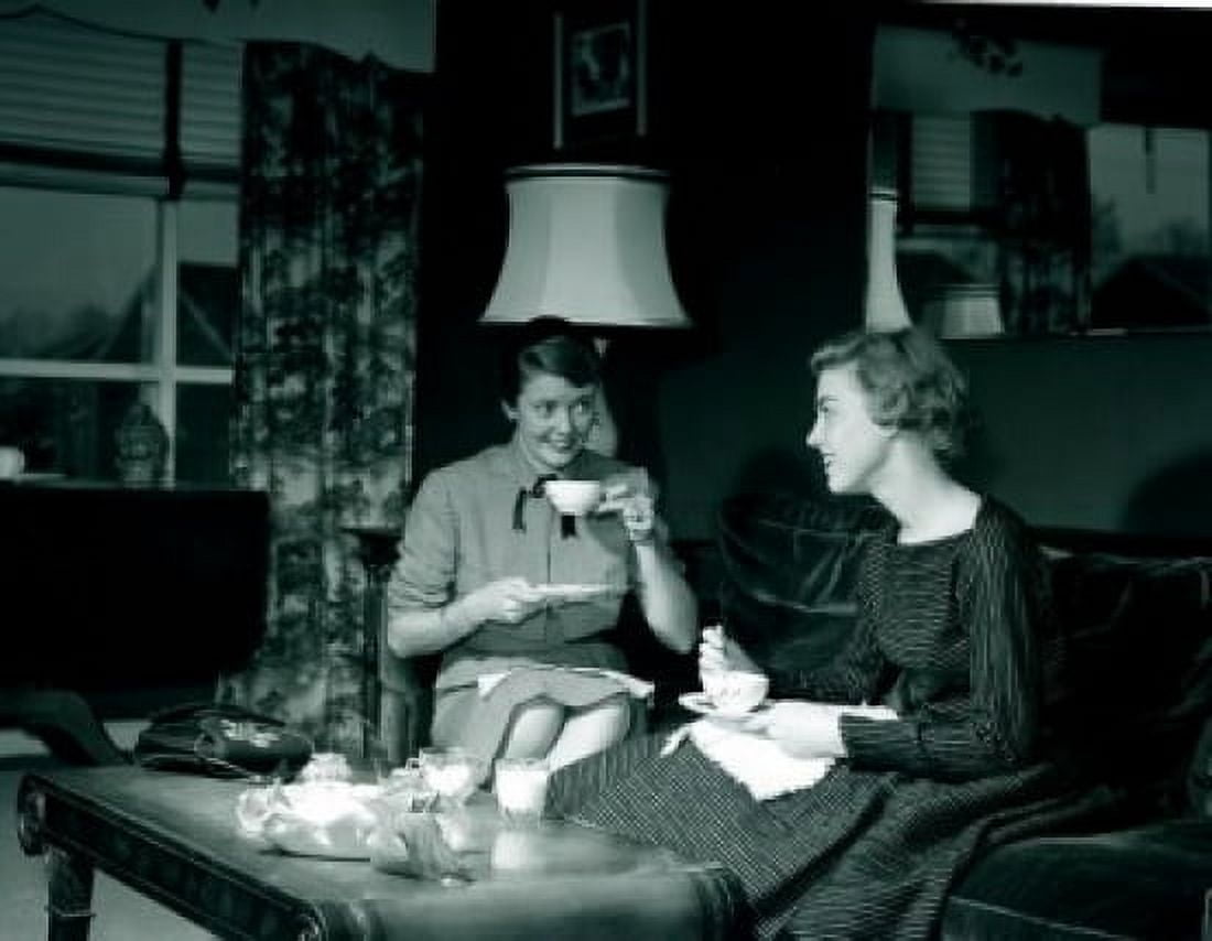 Two young women drinking tea in living room Canvas Art - (18 x 24)