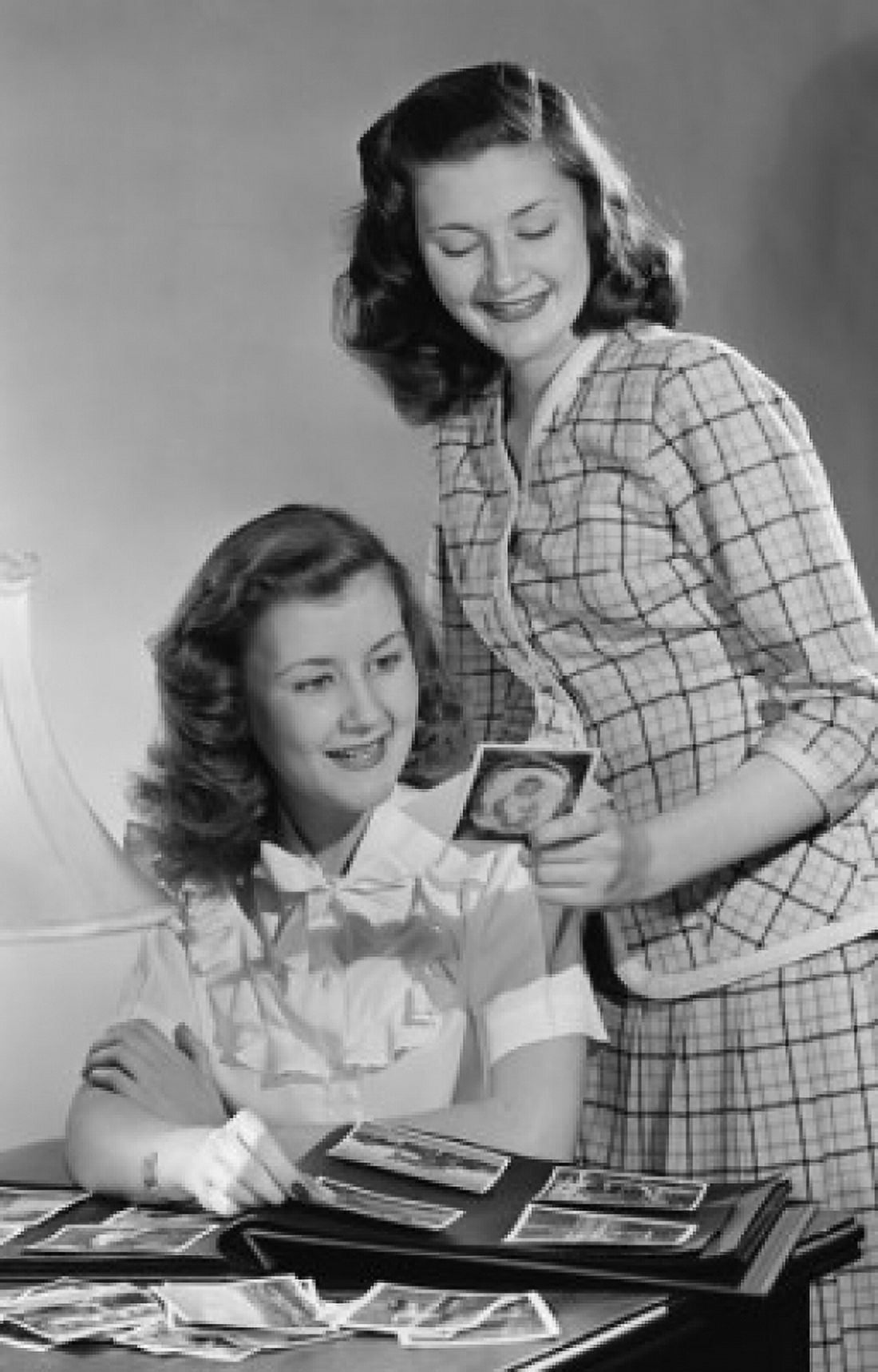 Two young women looking at pictures from photo album Canvas Art - (24 x 36)
