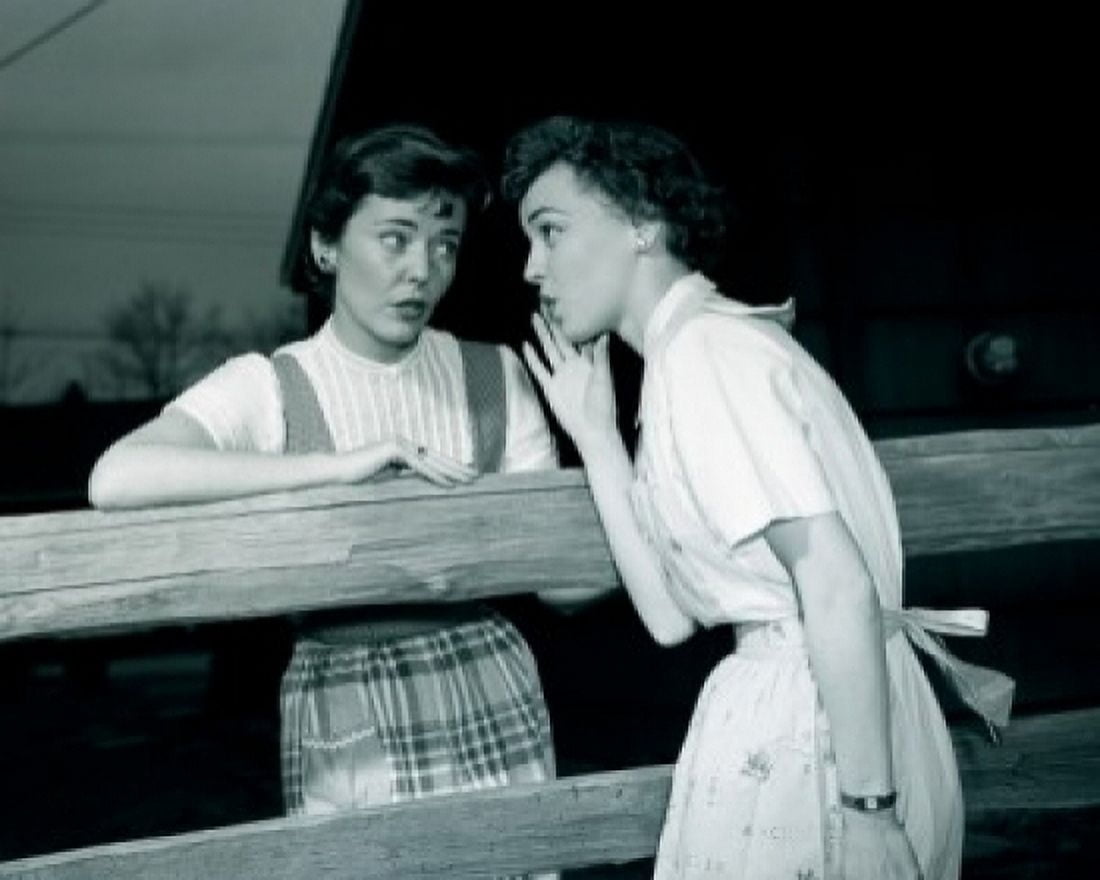 Two young women talking over fence Canvas Art - (24 x 36)