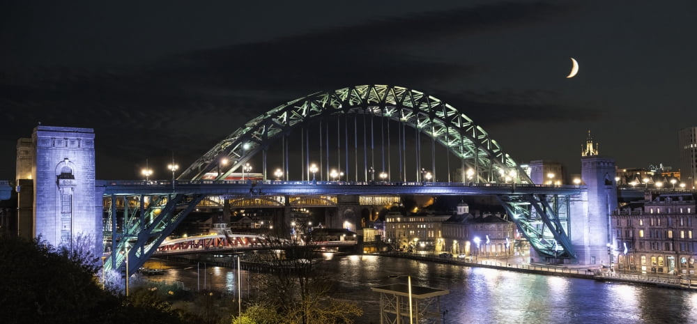 Tyne Bridge illuminated at nighttime over River Tyne with a crescent moon in the sky Newcastle Tyne and Wear England Canvas Art - John Short Design Pics (44 x 20)