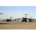 thumbnail image 1 of An U.S. Airman Dwarfed By A C-5 Galaxy Cargo Aircraft Signals The Plane Through A Crowded Runway At Moron Air Base Spain. The Planes Were Carrying Supplies And Soldiers To Afghanistan On Nov. 28 2001., 1 of 1