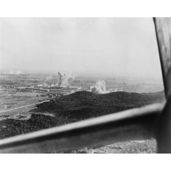 U.S. Carrier-Based Planes Bomb A Factory Plant Near Tokyo In 1945. Framing The Scene Is The Window Of An American