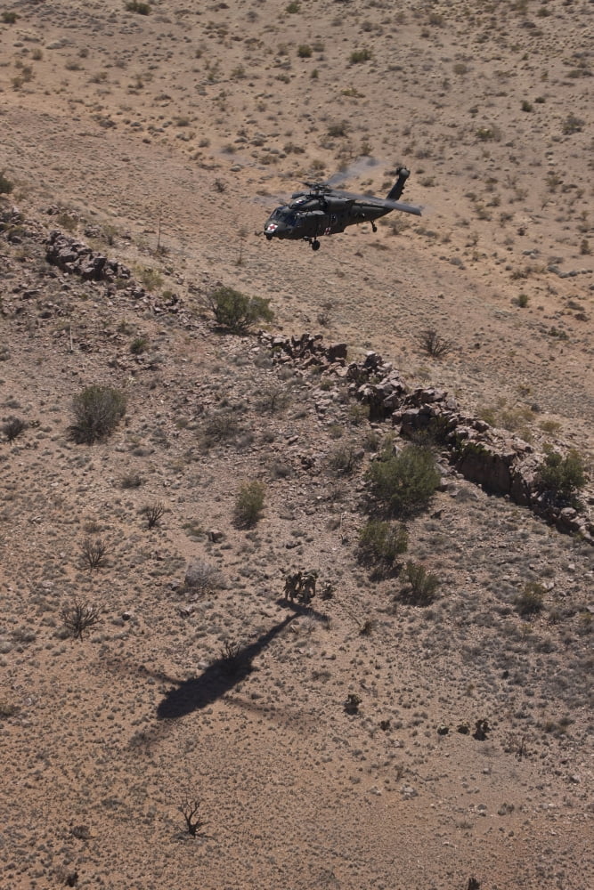 UH-60 Black Hawk hovers above US Marines for extraction Canvas Art - Terry MooreStocktrek Images (23 x 35)