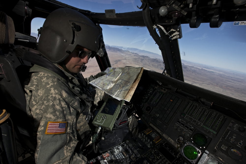 UH-60 Black Hawk pilot reading a map while in flight to New Mexico Canvas Art - Terry MooreStocktrek Images (18 x 12)