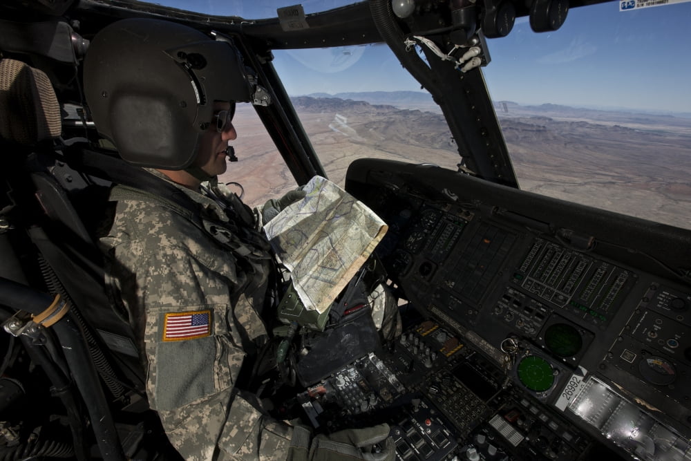 UH-60 Black Hawk pilot reading a map while in flight to New Mexico Canvas Art - Terry MooreStocktrek Images (35 x 23)
