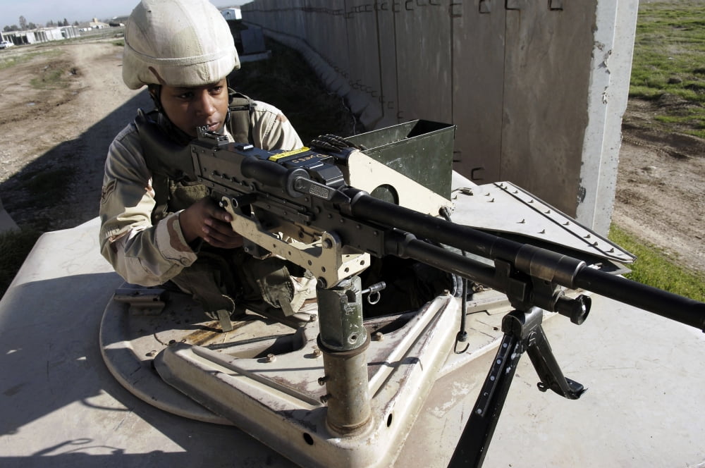 US Air Force Airman aims a M240B machine gun Canvas Art - Stocktrek Images (34 x 23)