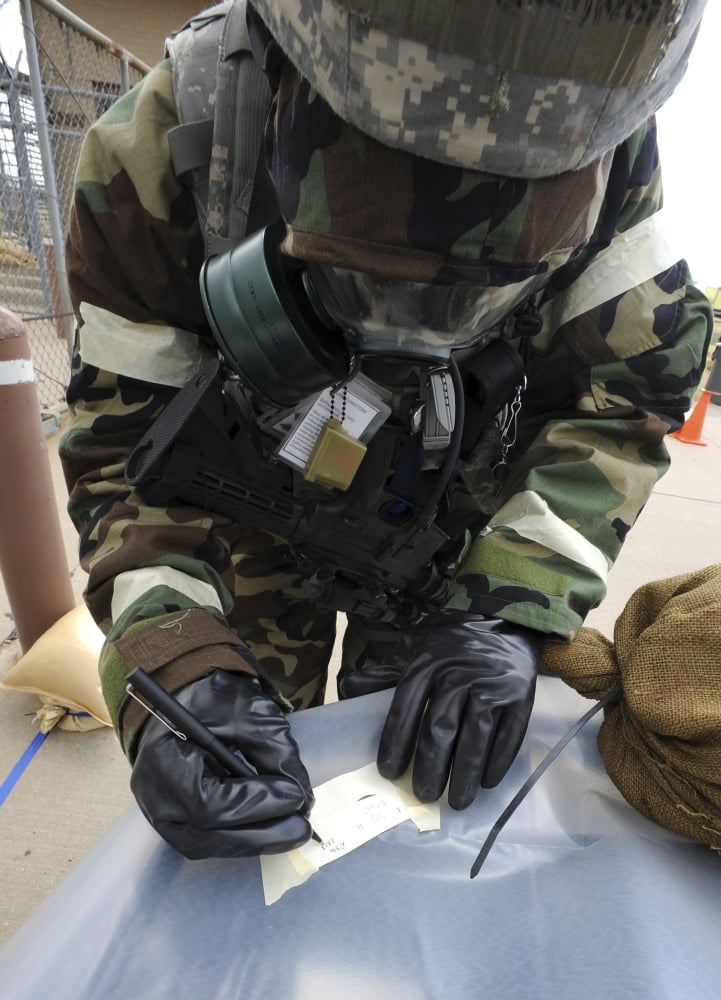 US Air Force Airman writes on M8 chemical detection paper during an operational readiness exercise Canvas Art - Stocktrek Images (24 x 33)