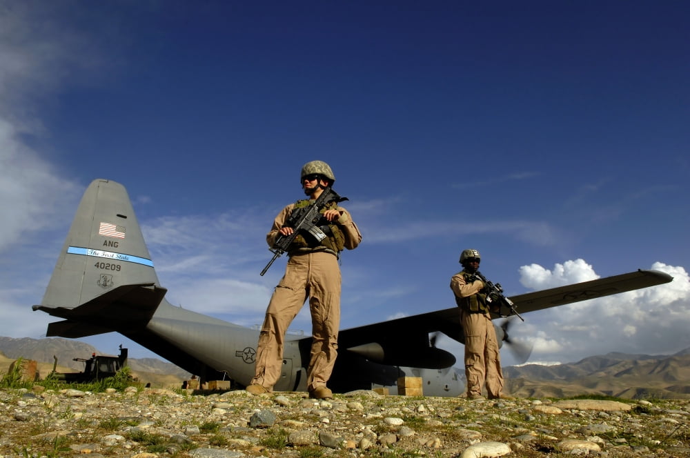 US Air Force Airmen provide security for a C-130 Hercules aircraft Canvas Art - Stocktrek Images (34 x 23)