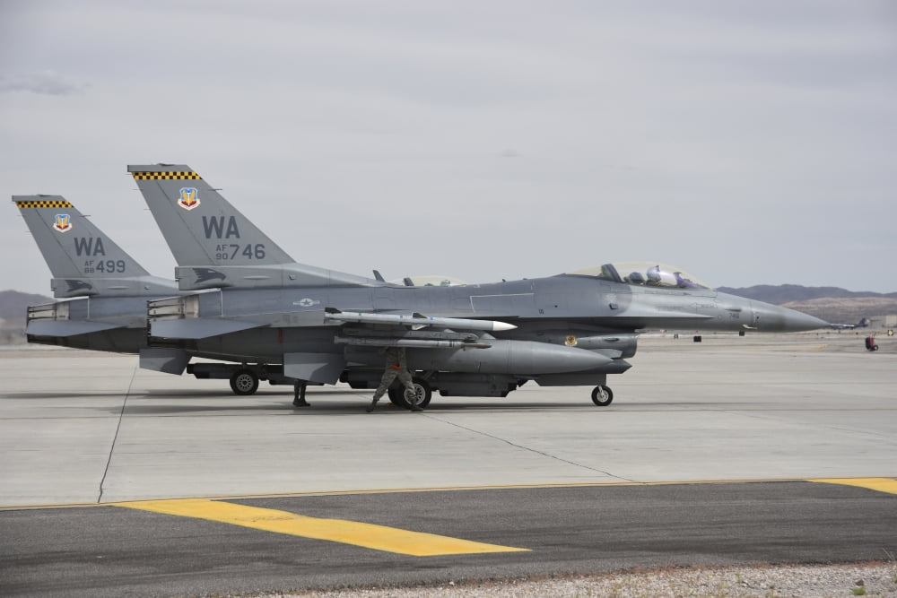 US Air Force F-16C planes undergo preflight checks at Nellis Air Force Base Canvas Art - Riccardo NiccoliStocktrek Images (34 x 23)