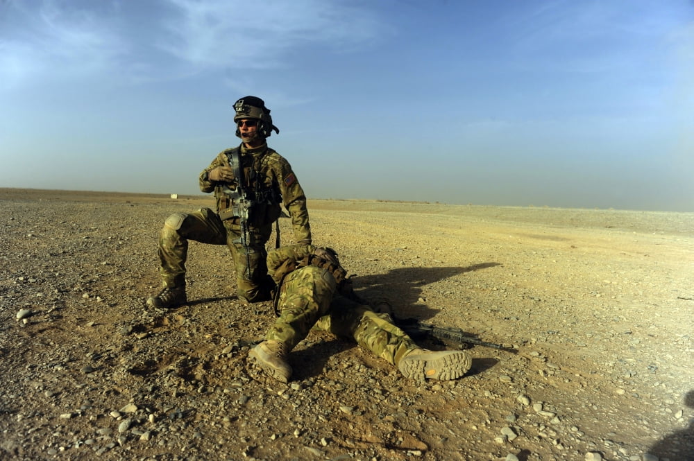 US Air Force captain protects an injured soldier while waiting for pickup Canvas Art - Stocktrek Images (34 x 23)