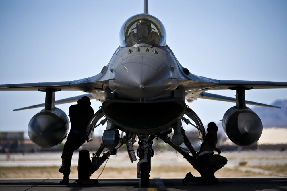 US Air Force crew chiefs do pre-flight checks under an F-16 Fighting Falcon Canvas Art - Stocktrek Images (35 x 23)