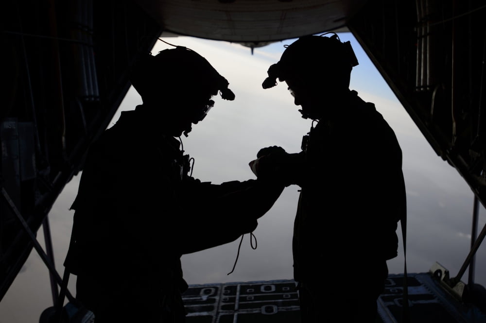 US Air Force loadmasters fold the American flag aboard an HC-130 Hercules Canvas Art - Stocktrek Images (34 x 23)