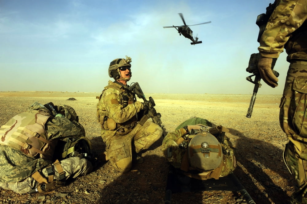 US Air Force members prepare to load casualties on an HH-60 Pave Hawk Canvas Art - Stocktrek Images (34 x 23)