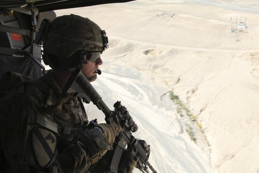 US Army Captain looks out the door of a UH-60 Black Hawk over Afghanistan Canvas Art - Stocktrek Images (35 x 23)