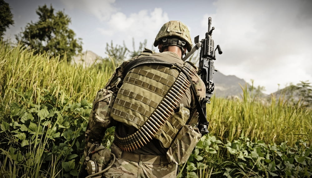 US Army MK48 machine gunner patrols through a field in Afghanistan Canvas Art - Stocktrek Images (37 x 21)