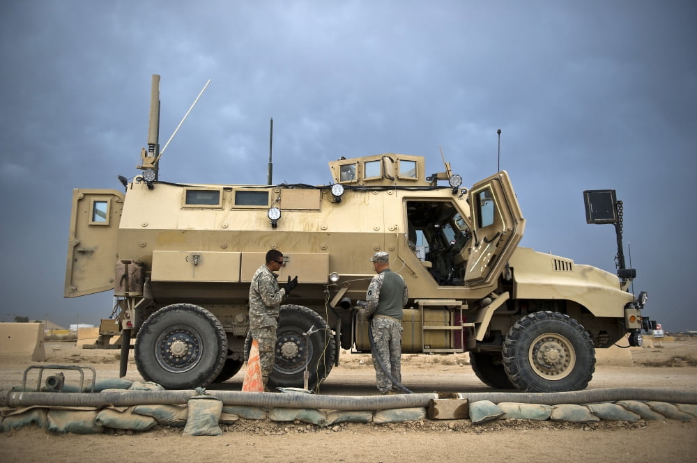 US Army Sergeant refuels a Caiman MRAP vehicle Iraq Canvas Art - Stocktrek Images (34 x 23)