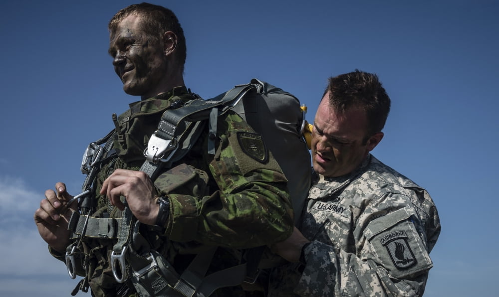 US Army Soldier helps Lithuanian Land Forces soldier prepare his parachute Canvas Art - Stocktrek Images (37 x 22)