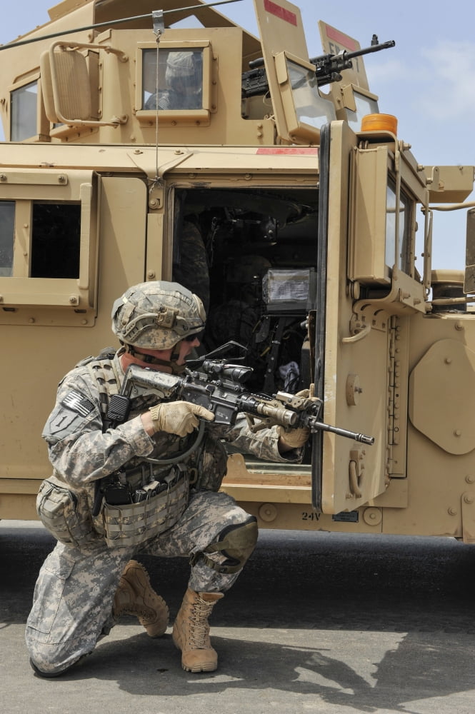 US Army Soldier shouts to a fellow soldier inside a humvee Canvas Art - Stocktrek Images (23 x 34)