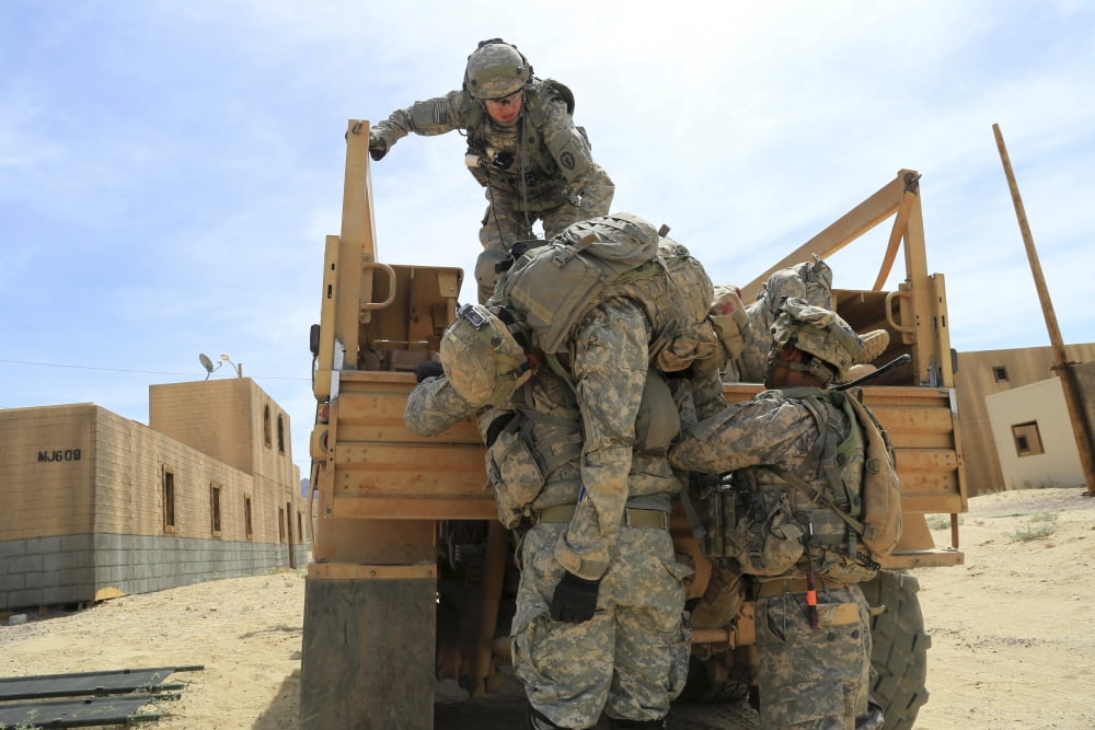US Army Soldiers lift a simulated casualty Canvas Art - Stocktrek Images (34 x 23)