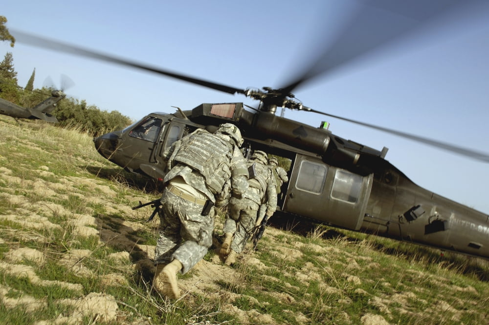 US Army Soldiers prepare to board a UH-60 Black Hawk helicopter Canvas Art - Stocktrek Images (34 x 23)