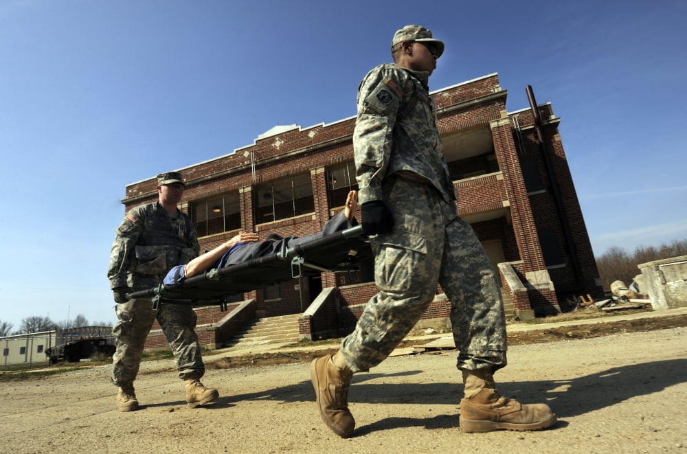 US Army Soldiers transport a manikin during a simulated attack Canvas Art - Stocktrek Images (35 x 23)