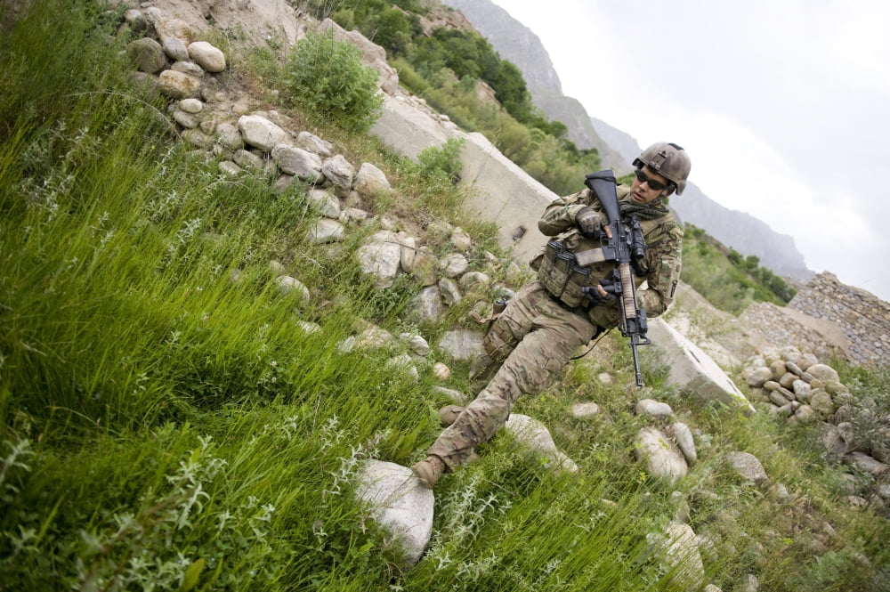 US Army Specialist walks through a field in Afghanistan Canvas Art - Stocktrek Images (35 x 23)