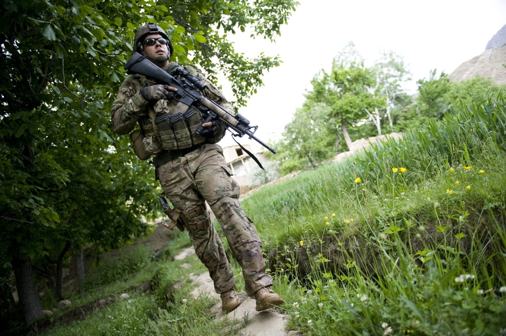 US Army Specialist walks through a field in Afghanistan Canvas Art - Stocktrek Images (35 x 23)