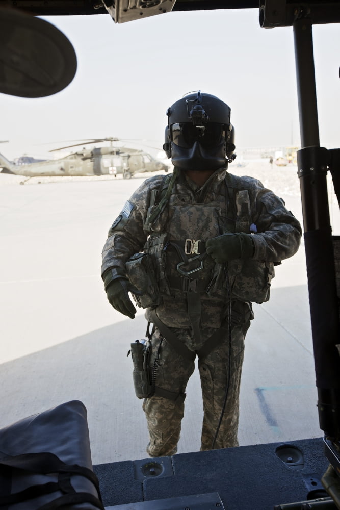 US Army UH-60L Loadmaster confirms pre-fliight check on his aircraft Canvas Art - Terry MooreStocktrek Images (12 x 18)