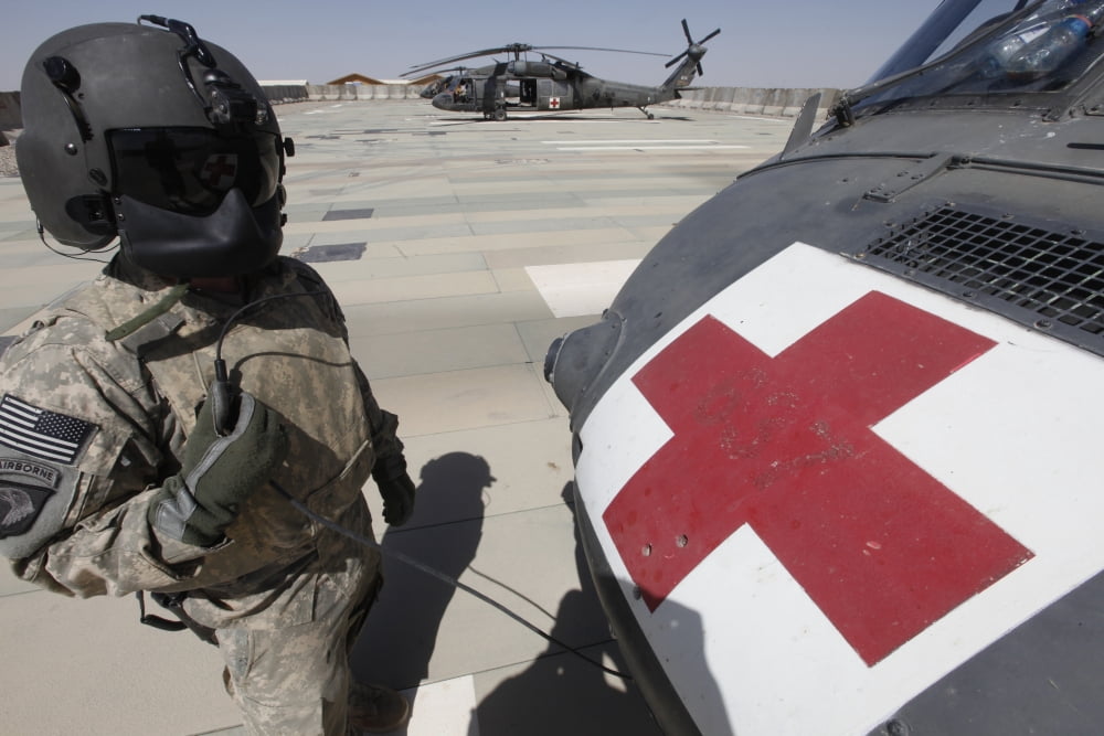 US Army crew chief inspects the exterior of a UH-60 Black Hawk Canvas Art - Stocktrek Images (34 x 23)