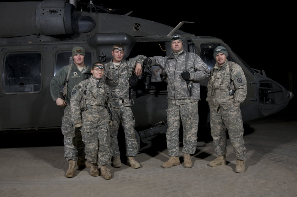 US Army crew chiefs pose in front of their UH-60 Black Hawk Canvas Art - Terry MooreStocktrek Images (18 x 12)