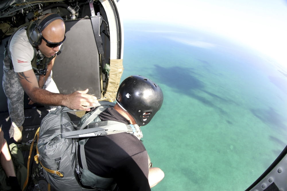 US Army jumpmaster prepares a paratrooper to jump out of a MH-60 Black Hawk Canvas Art - Stocktrek Images (34 x 23)