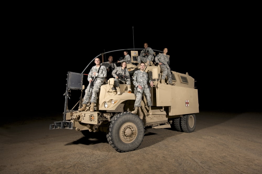 US Army medical personnel pose for a group photo atop their MRAP vehicle Canvas Art - Terry MooreStocktrek Images (18 x 12)