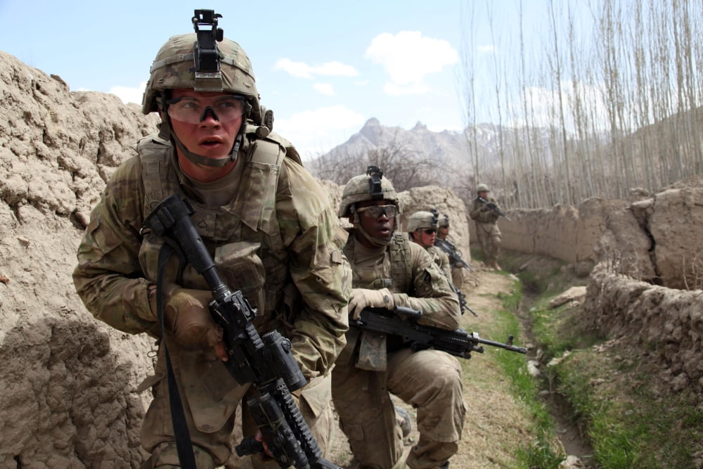US Army platoon moves in behind mud walls Canvas Art - Stocktrek Images (34 x 23)
