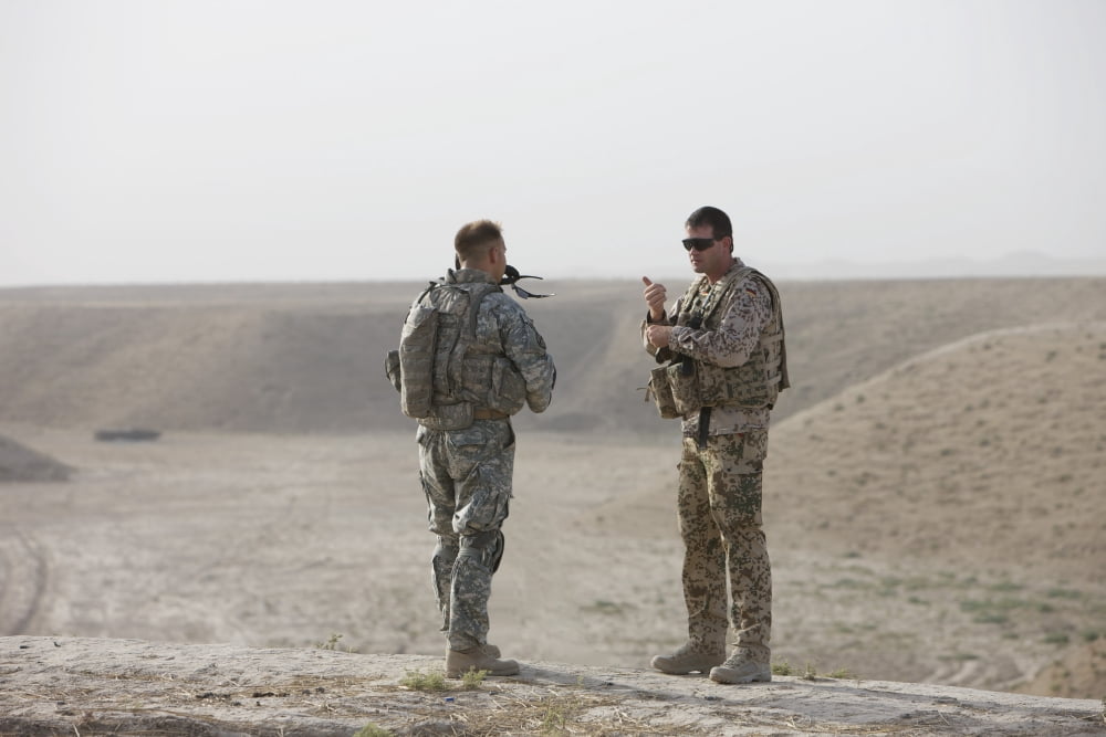 US Army soldier and German soldier stand on top of a wadi in Afghanistan Canvas Art - Terry MooreStocktrek Images (35 x 24)