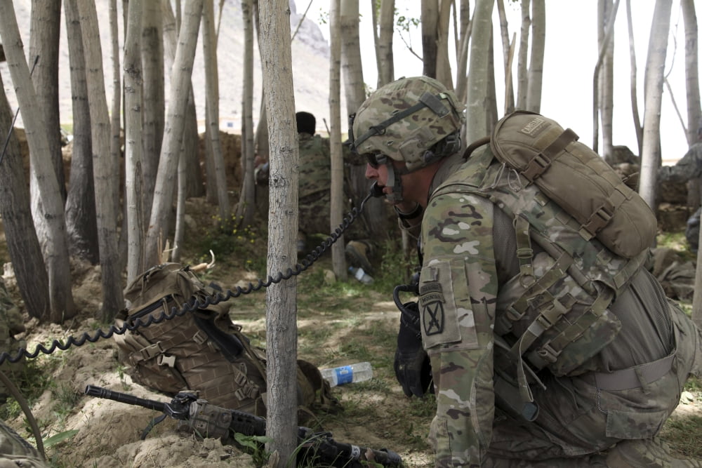 US Army soldier communicates possible enemy locations during combat in Afghanistan Canvas Art - Stocktrek Images (35 x 23)