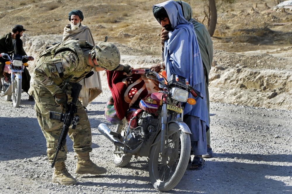 US Army soldier conducts vehicle and personnel searches at a checkpoint in Afghanistan Canvas Art - Stocktrek Images (35 x 23)