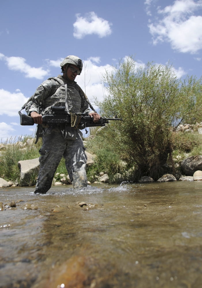US Army soldier crosses a stream while on patrol in the Zabul province of Afghanistan Canvas Art - Stocktrek Images (24 x 33)