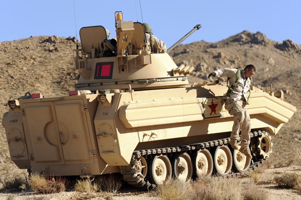 US Army soldier jumps off an M113 armored personnel carrier Canvas Art - Stocktrek Images (35 x 23)