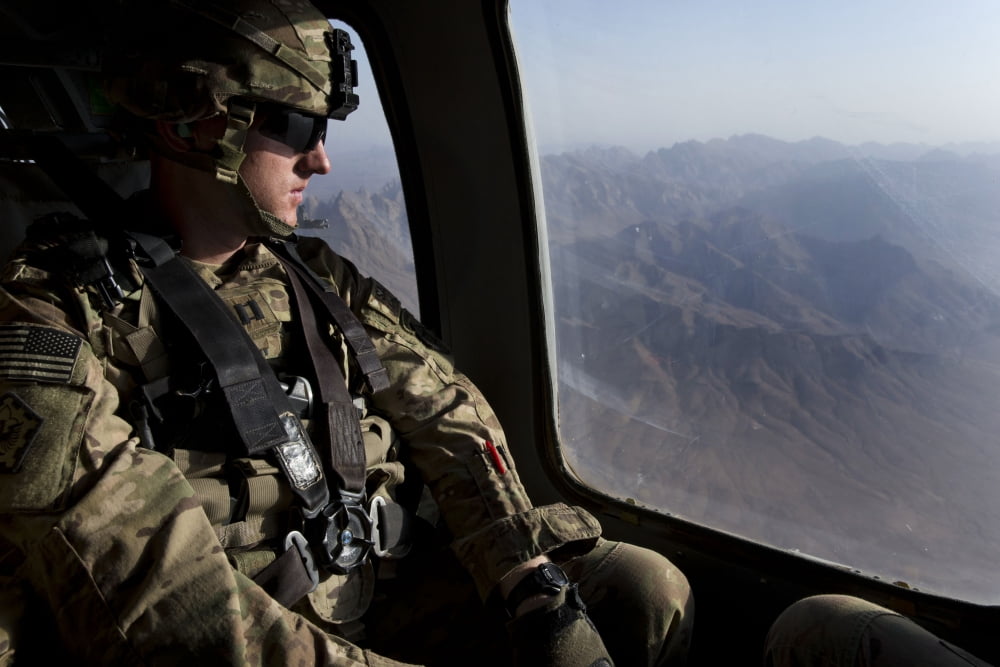 US Army soldier looks out the window of a UH-60 Black Hawk helicopter Canvas Art - Stocktrek Images (35 x 23)