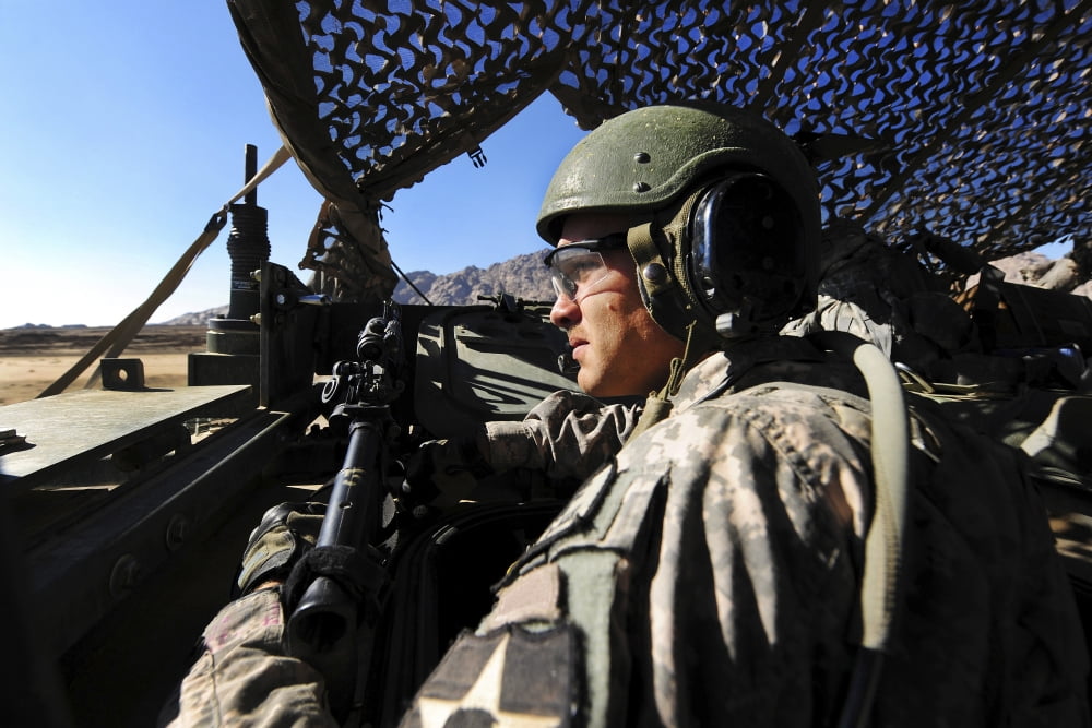 US Army soldier mans the air guard position inside a Stryker armored vehicle Canvas Art - Stocktrek Images (34 x 23)