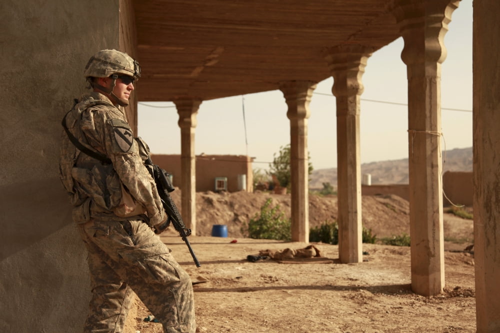 US Army soldier pulls security beside an Iraqi home Canvas Art - Stocktrek Images (35 x 23)
