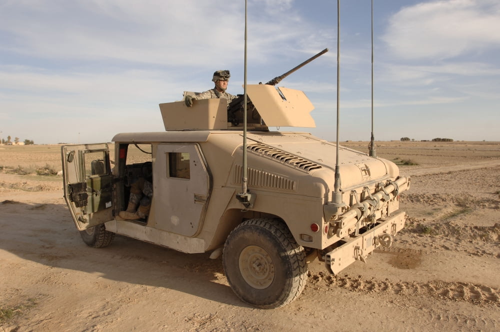 US Army soldier pulls security on top of a M1114 Armored HMMWV Canvas Art - Stocktrek Images (35 x 23)