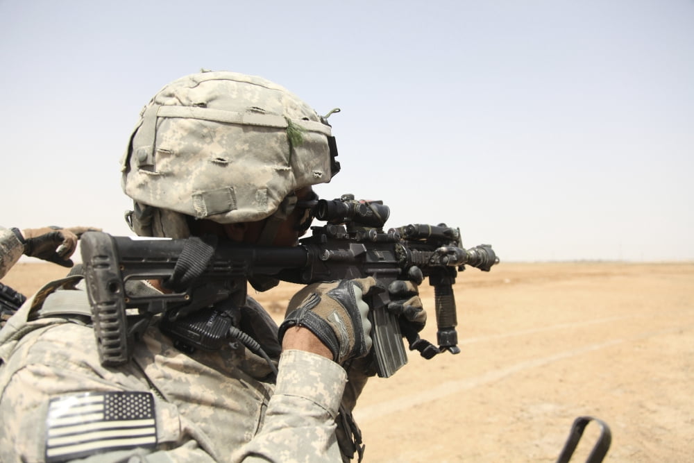 US Army soldier scans the horizon through the scope of a M4 carbine Canvas Art - Stocktrek Images (35 x 24)