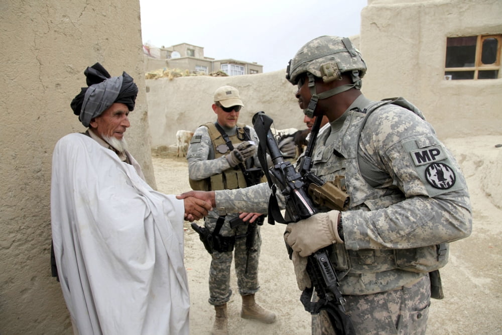 US Army soldier shakes hands with an elder in a village in Afghanistan Canvas Art - Stocktrek Images (34 x 23)