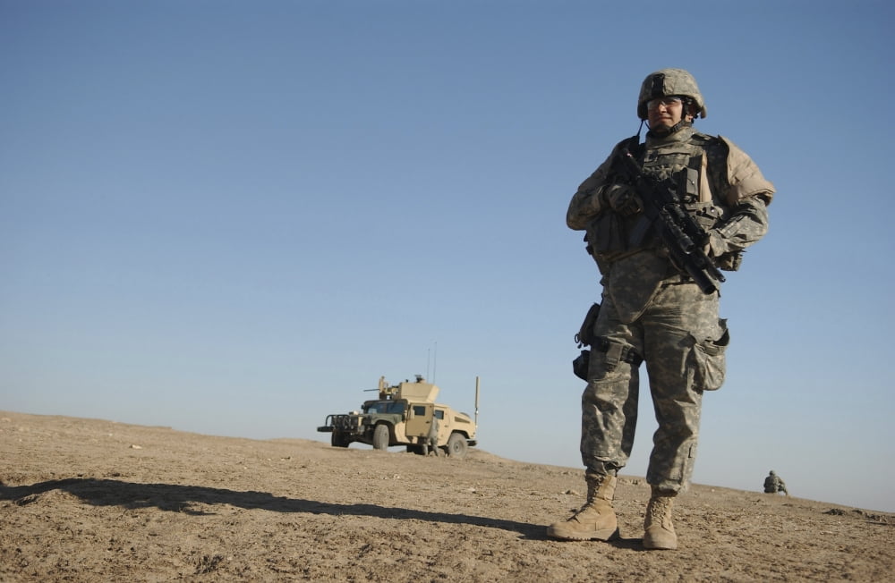 US Army soldier standing watch near an Iraqi police checkpoint in Tall Afar Iraq Canvas Art - Stocktrek Images (34 x 23)