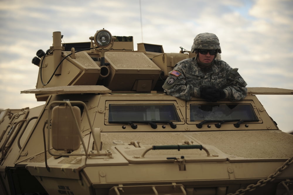 US Army soldier stands in the drivers hatch of an M1117 Guardian Armored Security Vehicle Canvas Art - Stocktrek Images (34 x 23)