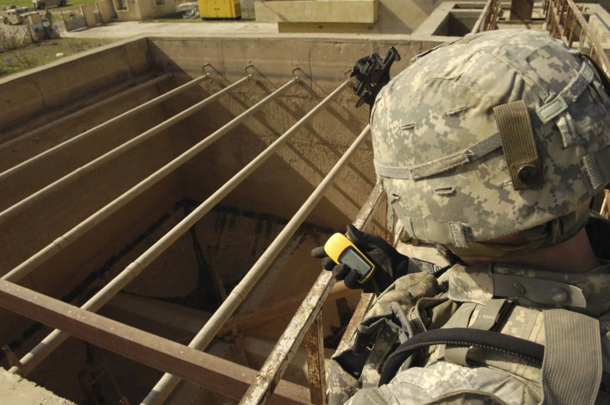 US Army soldier takes a GPS grid reading at a water treatment plant Canvas Art - Stocktrek Images (35 x 23)