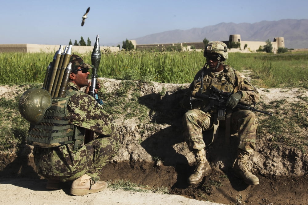US Army soldier takes a break with an Afghan National Army soldier Canvas Art - Stocktrek Images (35 x 23)