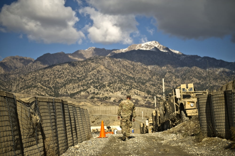 US Army soldier walks down a path at Combat Outpost Herrera Canvas Art - Stocktrek Images (35 x 23)